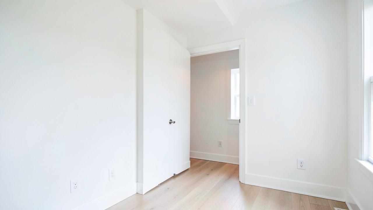 Newly finished basement room with fresh paint and trim